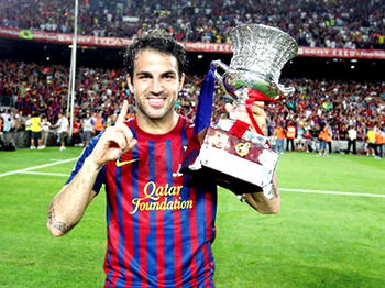 Six years after, Fabregas relieved, wins a medal