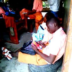 Lagos secondary school where students sit on floor, windows to receive lectures