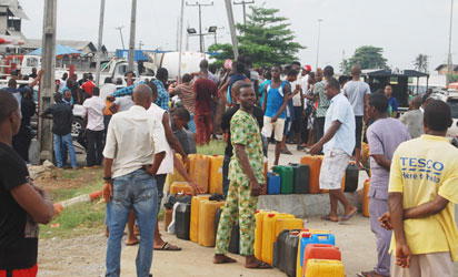 Long queue of jerry cans at a petrol station as fuel scarcity bites 