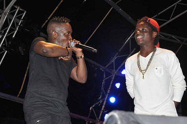 M.I. signs new lookalike protégé live onstage in abuja concert