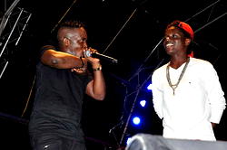 M.I. signs new lookalike protégé live onstage in abuja concert
