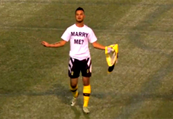 Video: Soccer player booked for making marriage proposal mid-game