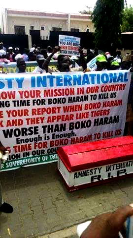 Protesters protest with red coffin, say AI must quit Nigeria