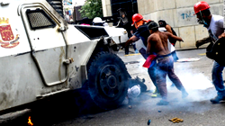 Armoured vehicle rolls over Venezuelan protester