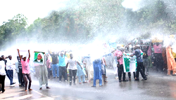 Photos: Police tear gas El-Zakzaky protesters in Abuja with water Canons.