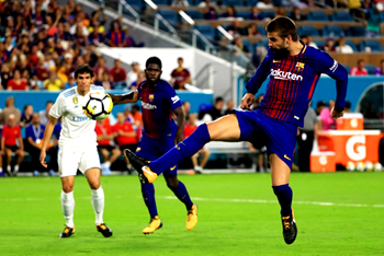 Pique lifts Barcelona as El Clasico lives up to hype