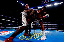 Joshua stops Takam in 10th round to retain heavyweight crowns