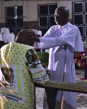 Ven. Stanley Awuzie praying for Chief Osita Chidoka