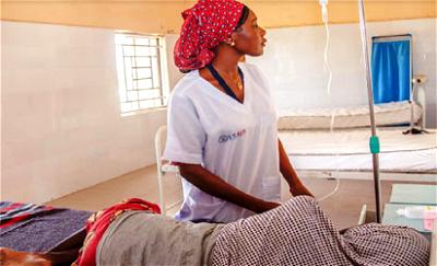 A USAID-supported nurse sets an IV line for a patient at the Dikwa General Hospital, Borno State.