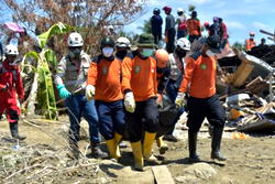 French Rescuers search for bodies in debris of Indonesian quake disaster