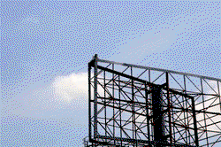 Breaking: Angry man climbs billboard hanger, vows not to come down till Atiku shows up