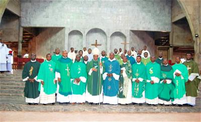 Catholic Bishop of Nsukka Diocese, Most Rev. Godfrey Igwebuike Onah flanked by some priests in the Diocese