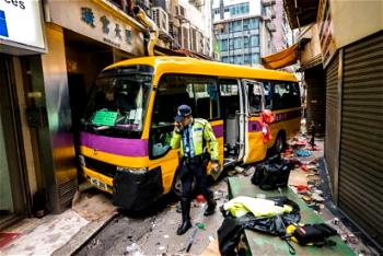 Three killed as Hong Kong schoolbus mounts pavement, trapping passers-by