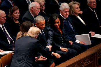 George W. Bush has sweet exchange with Michelle Obama at father’s funeral