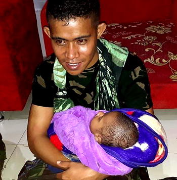 Baby reunited with dad as Indonesia flood death toll hits 79