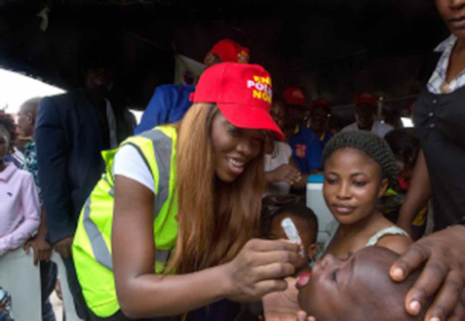Tiwa Savage immunising a child against polio.