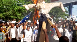 Masked group targets US embassy with arson attack during protests