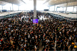 Hong Kong airport grinds to a halt as protests swell