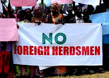 Placard carriers at NLTP Launch laud scheme, oppose mobile husbandry