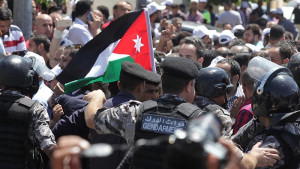 Teachers jostle with security forces during a protest in Amman