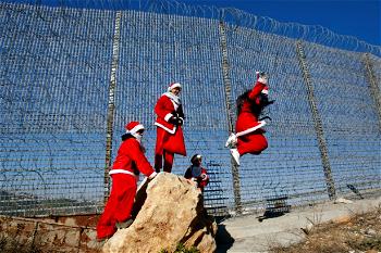 Bethlehem lights up Christmas tree as virus rules keep crowds away