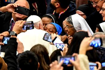 ‘Don’t bite!’ quips pope as he kisses nun
