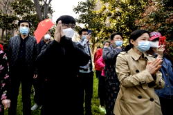 China virus epicentre to open up as world locks down