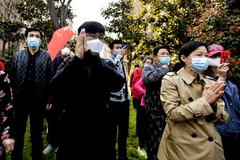 China virus epicentre to open up as world locks down