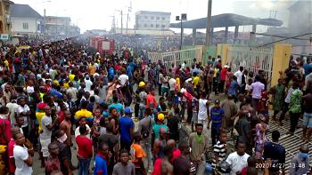 PHOTOS: Lagosians defy social distancing order as fire guts NNPC station in Ogba