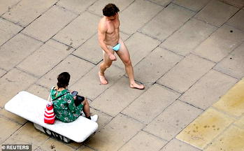 Man wears G-string fashioned from face mask, parades London street