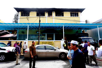 Malaysian court jails teenager for killing 23 people in school fire
