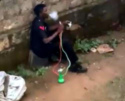 [ICYMI] CAUGHT ON CAMERA: Man in Nigerian Police uniform heavily smoking shisha (VIDEO)