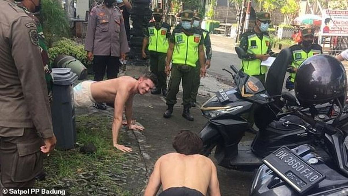 Foreigners without face masks punished with push-ups in Indonesia