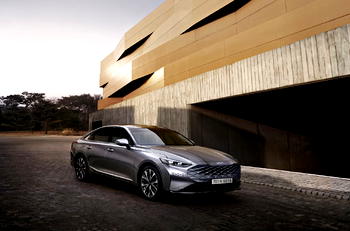 KIA K8 sedan hits the road, wears new logo
