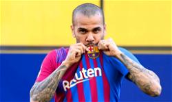 This feels like titles and trophies, delighted Dani Alves smells Camp Nou grass