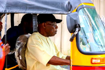 Obasanjo rides tricycle, urges youths to embrace opportunities