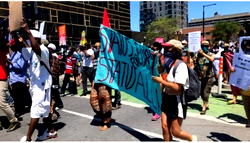 Protesters march to demand legal status for migrants in Canada
