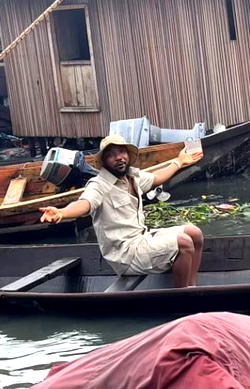 Makoko residents surprised as popular lagos big boy surfaces on local boat, passes message of hope