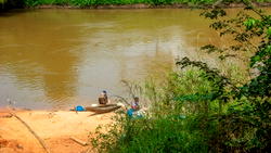 One dies as vehicles crash, plunge into river