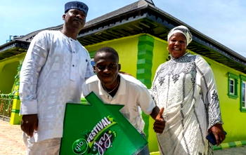 Glo presents house prize to teenage winner in Festival of Joy promo