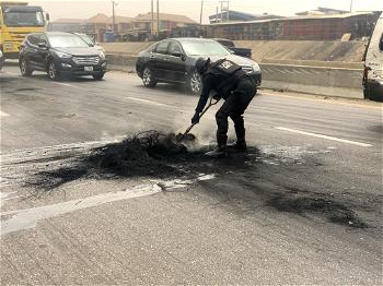 Policemen clear debris left by protesters on Lagos-Ibadan Expressway