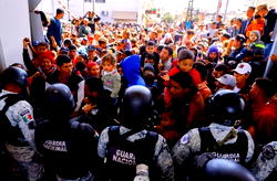 Migrants storm Mexico border to enter US