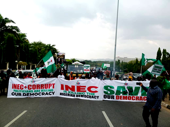 INEC-chairman-must-go protesters defy afternoon rains, storm Appeal Court