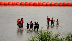 Biden administration sues Texas over floating border barriers to restrict migrants