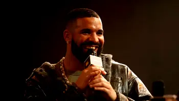 Drake poses with collection of bras thrown at him during concerts