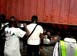 Three escape death as truck crushes car at Ojuelegba