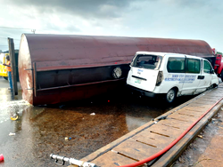 Petrol tanker loses control, traps bus in Lagos
