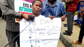Photos: Little protester writes Tinubu to pay her school fees