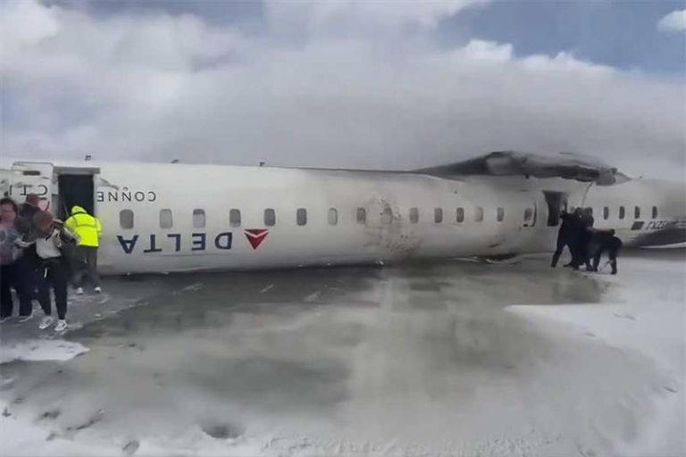 Delta plane comes to rest upside down after flipping over while landing