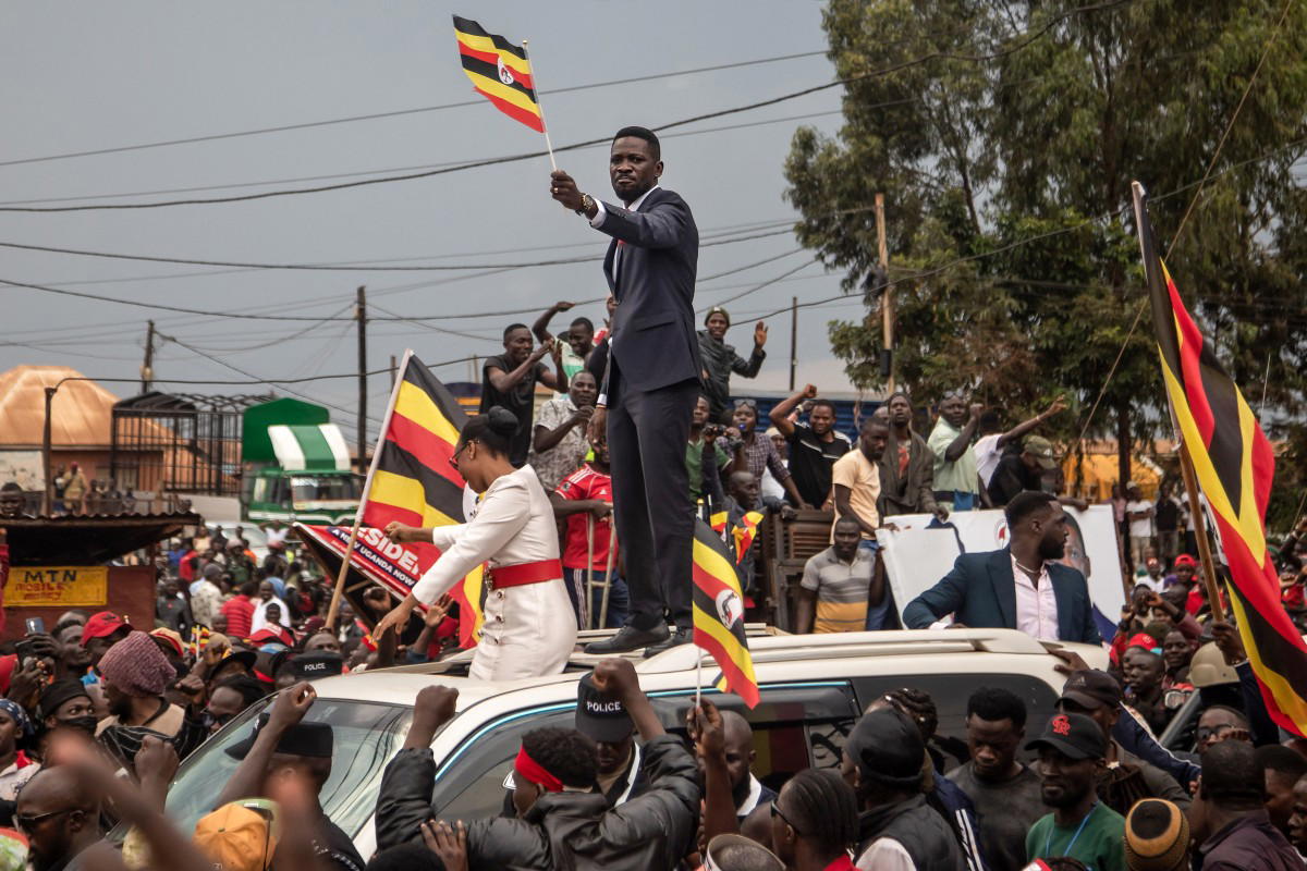 Police officers manage a large crowd during a public gathering in Uganda.